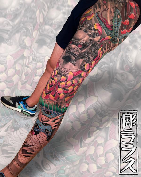 Foo dog and snake with chrysanthemum leg tattoo