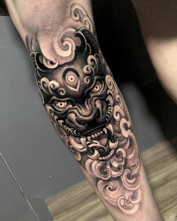 Foo dog calf tattoo black and grey