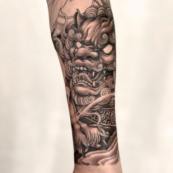 Foo dog forearm tattoo