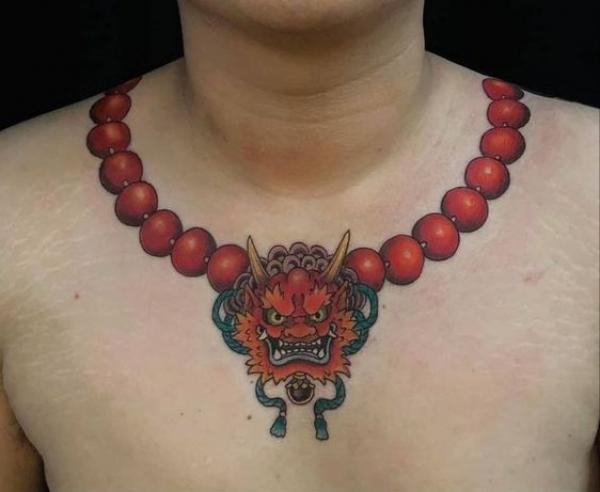 Foo dog necklace tattoo