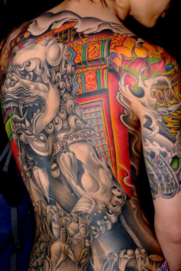 Foo dog statue with lotus back tattoo