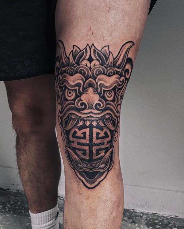 Foo dog tattoo on knee