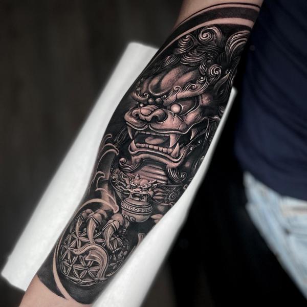 Foo dog with ball tattoo sleeve