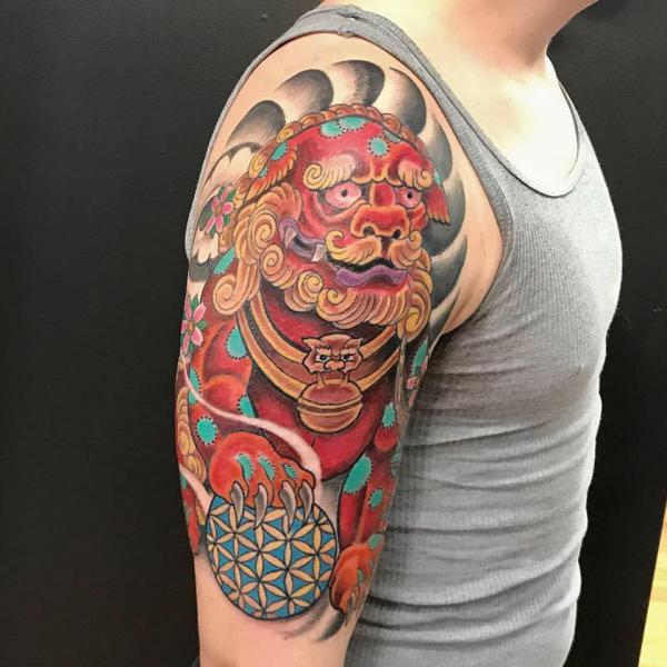 Foo dog with flower of life ball tattoo