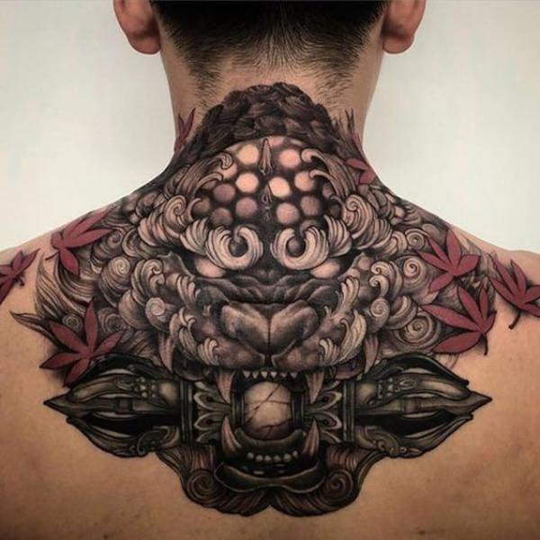 Foo dog with maple leaves neck tattoo