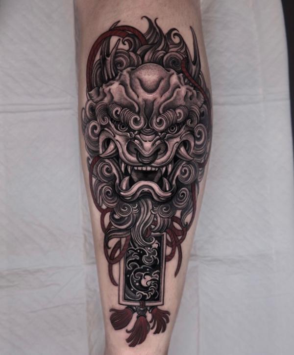 Foo dog with omamori tattoo