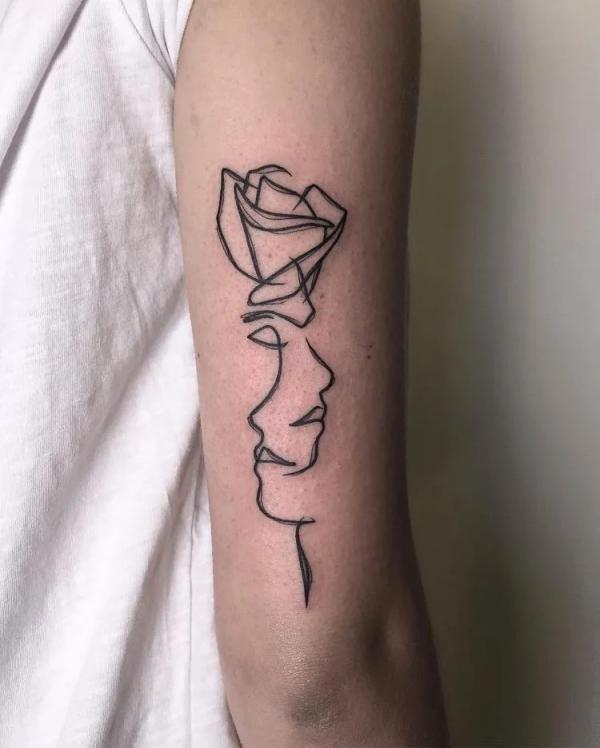 Gemini face and rose outline tattoo