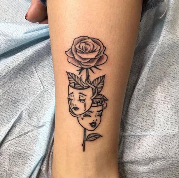 Gemini face with rose tattoo