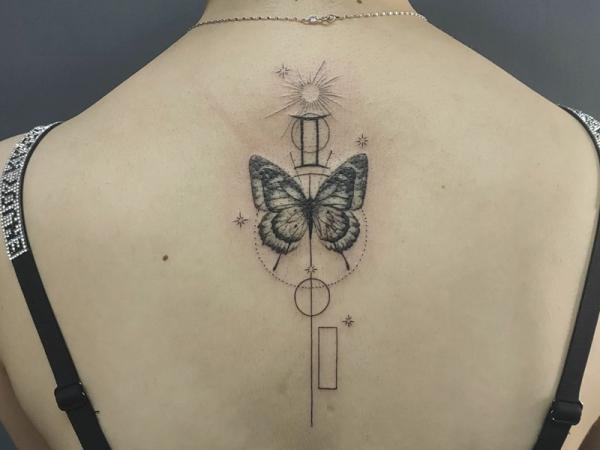 Gemini glyph and butterfly with sun and moon tattoo