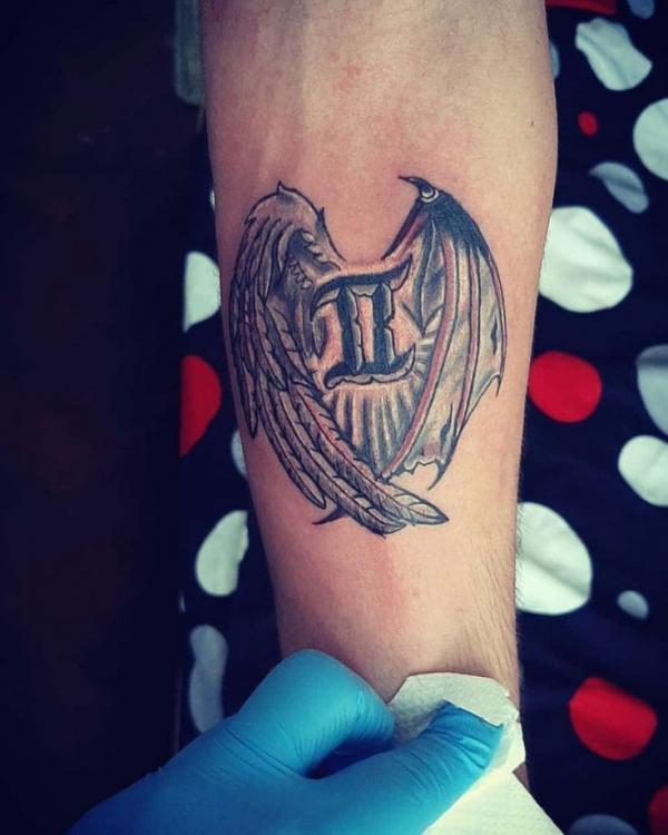 Gemini glyph angel and devil wings tattoo