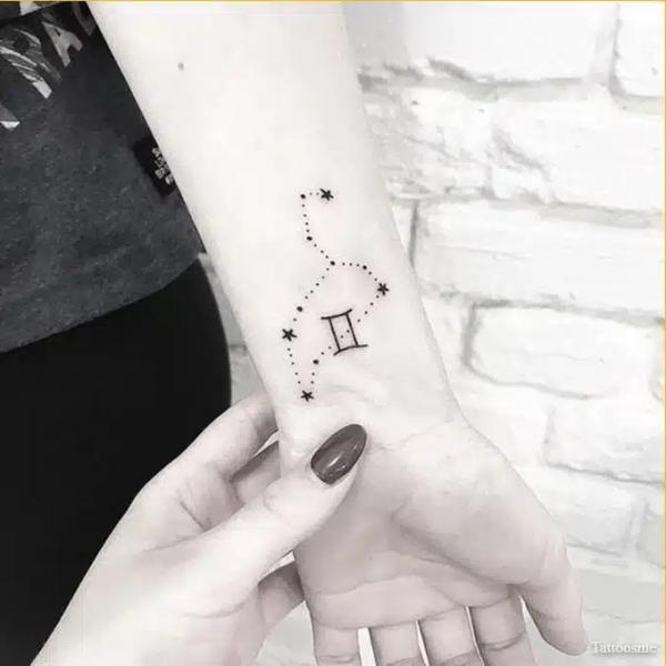 Gemini glyph on Leo constellation wrist tattoo