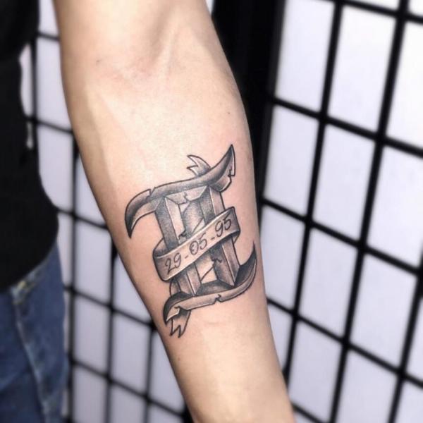Gemini glyph with date tattoo