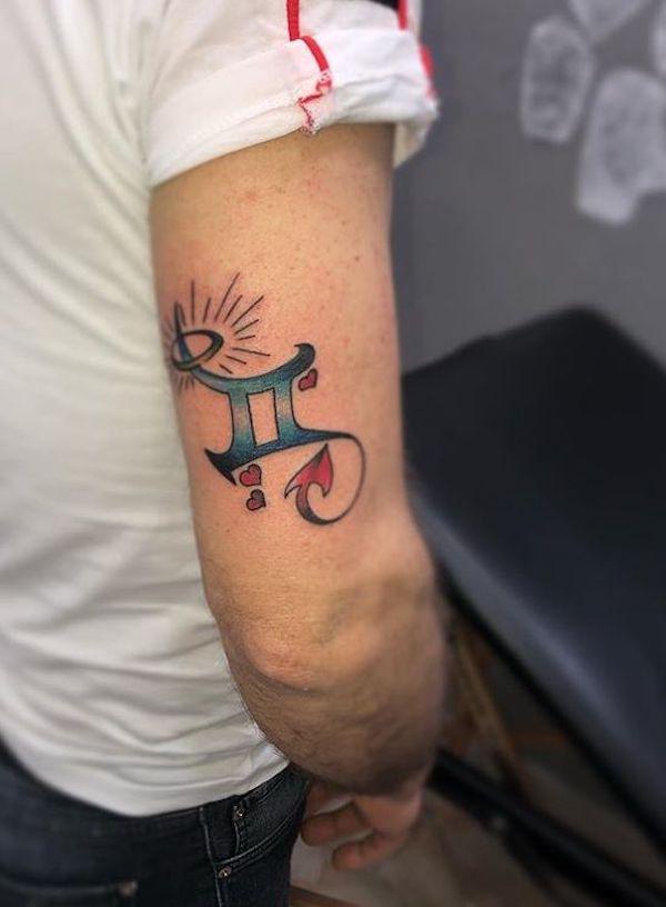 Gemini glyph with halo and hearts back of arm tattoo