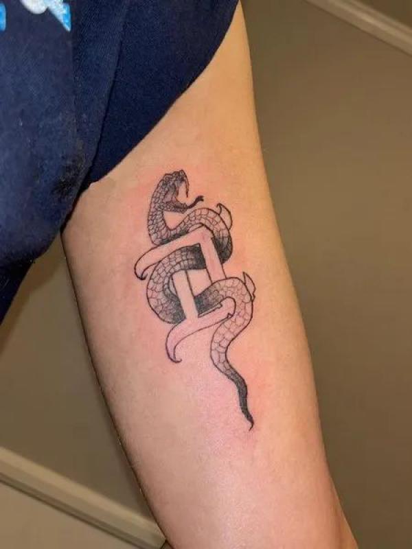 Gemini glyph with snake tattoo