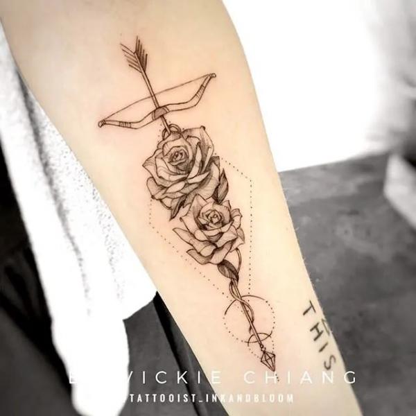 Geometric Sagittarius bow and arrow with roses tattoo