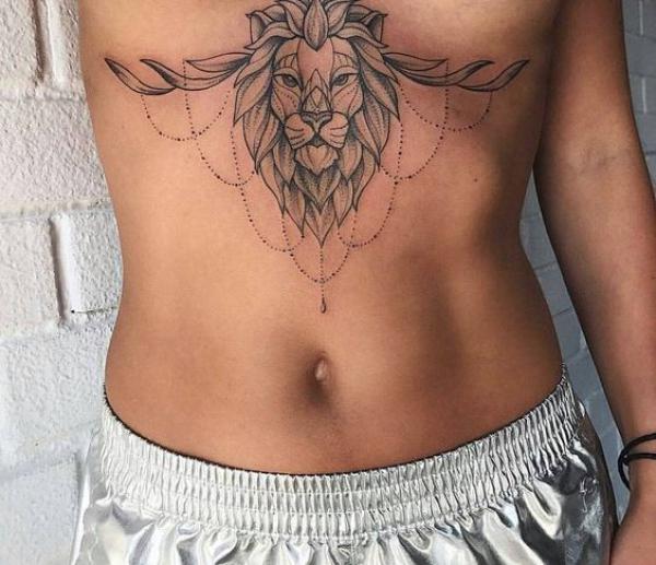 Geometric lion head sternum tattoo