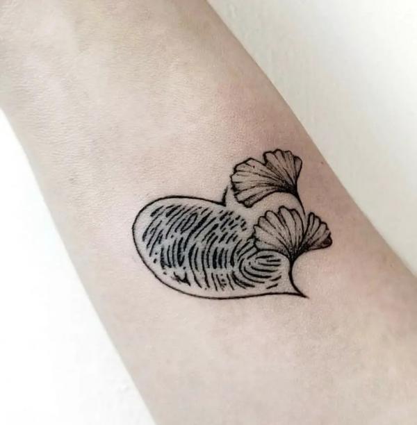 Ginkgo leaf and figerprint heart tattoo on arm
