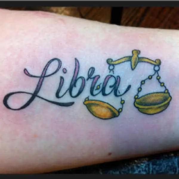Golden Libra scales with lettering tattoo