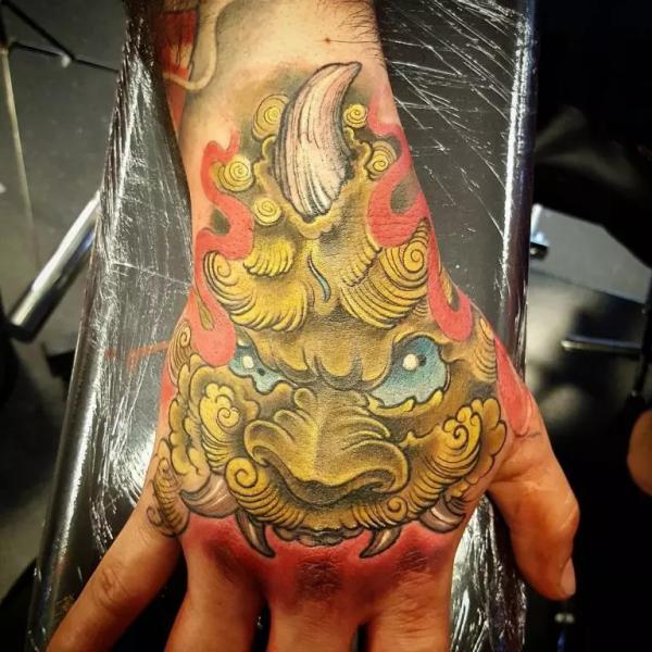 Golden foo dog hand tattoo