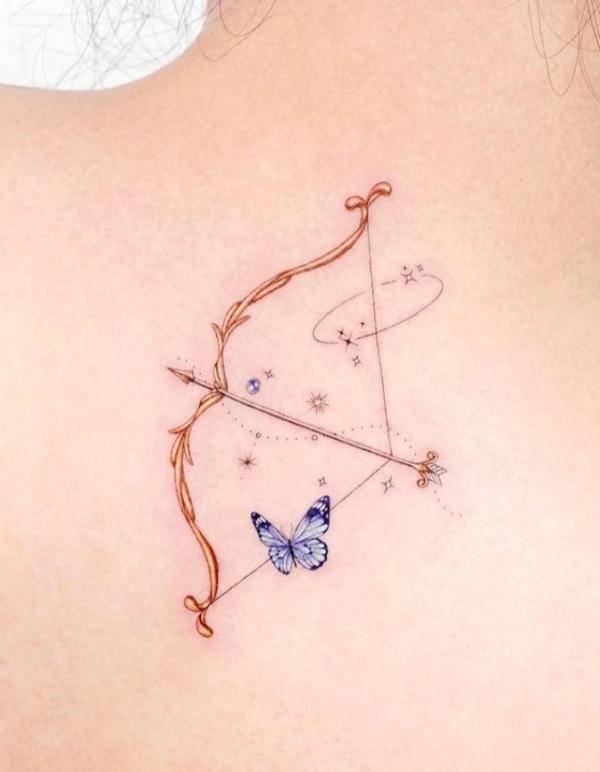 Golden sagittarius bow and arrow with blue butterfly tattoo