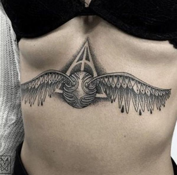 Golden snitch with wings sternum tattoo