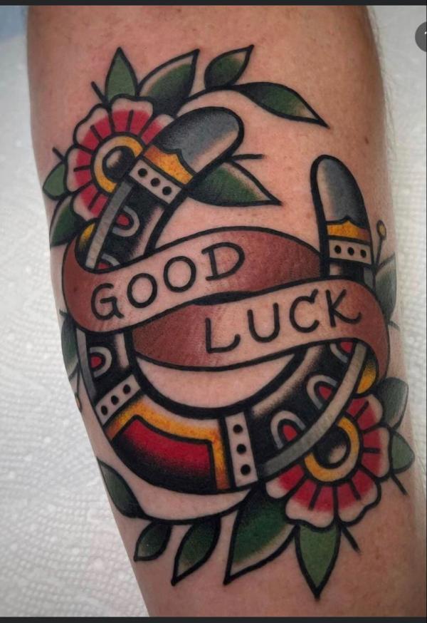 Good luck horseshoe with flower tattoo