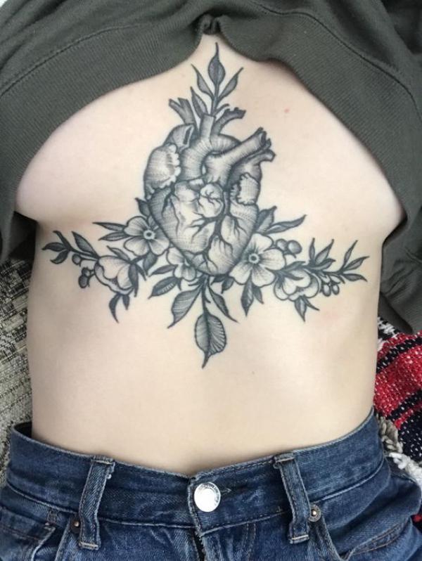 Greyscale heart with flowers sternum tattoo