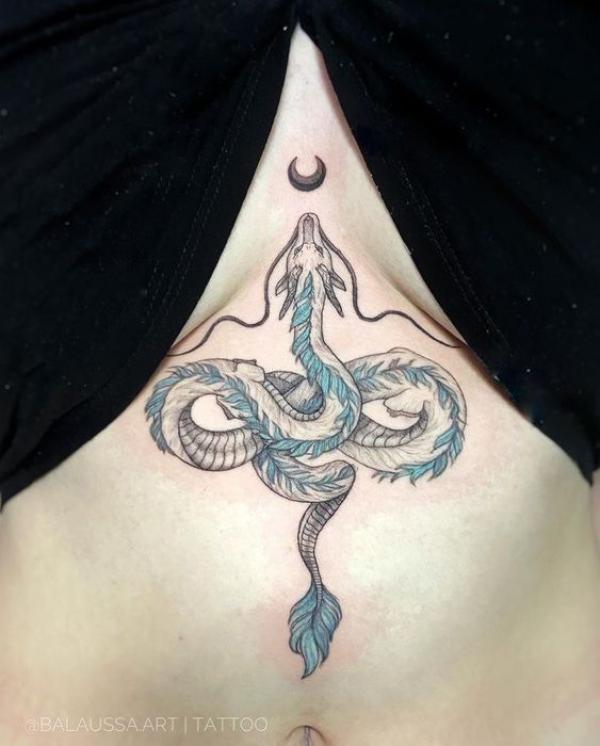 Haku dragon and moon sternum tattoo