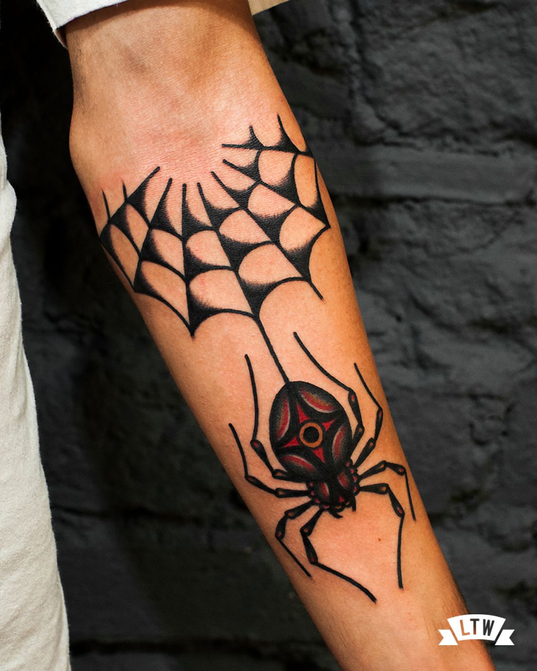 Half spider with a spider elbow tattoo