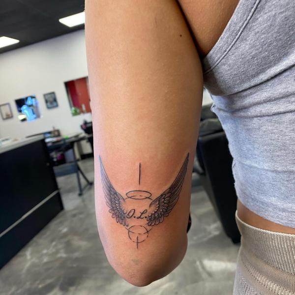 Halo wings back of arm tattoo