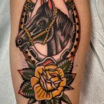 Horse and horseshoe with yellow rose tattoo traditional