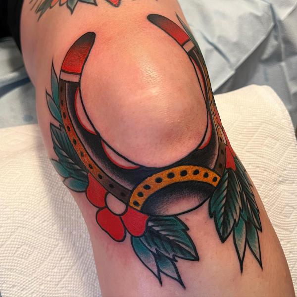 Horseshoe knee tattoo traditional