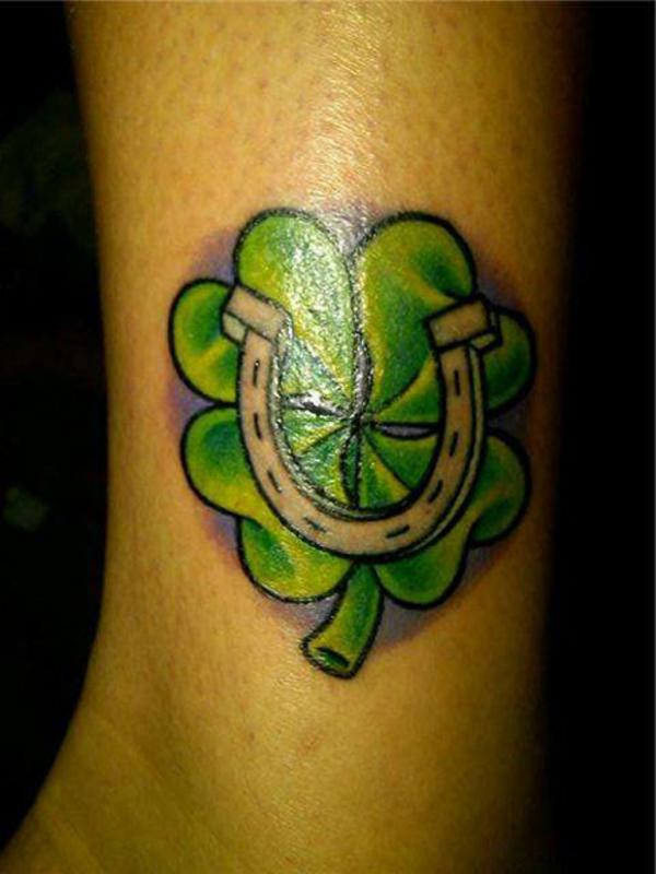 Horseshoe on shamrock flower tattoo