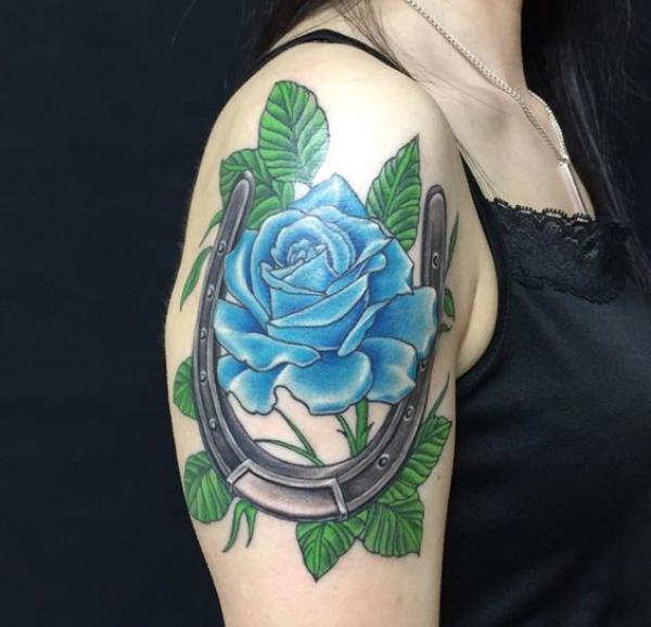 Horseshoe with blue rose tattoo
