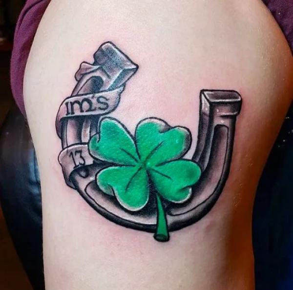 Horseshoe with four leaf clover and number 13 tattoo