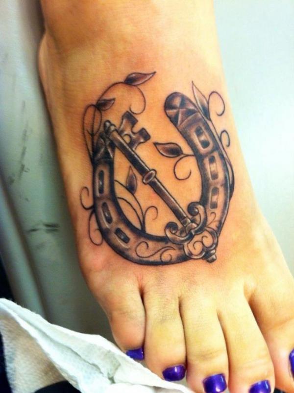Horseshoe with key foot tattoo