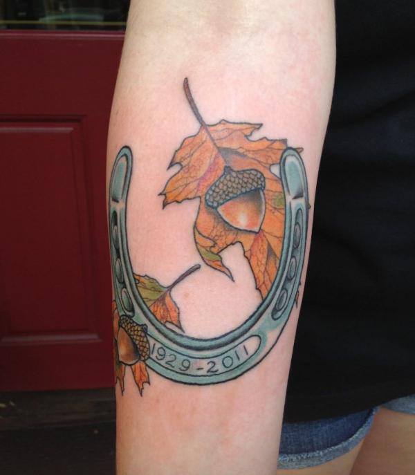 Horseshoe with maple leaf and acorn tattoo