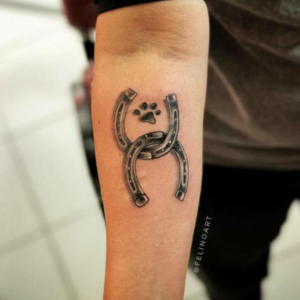 Horseshoe with paw print tattoo
