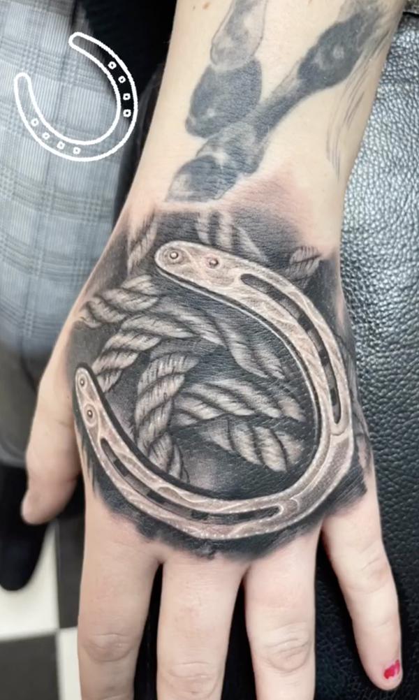 Horseshoe with rope hand tattoo