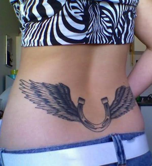 Horseshoe with wings low back tattoo black and grey