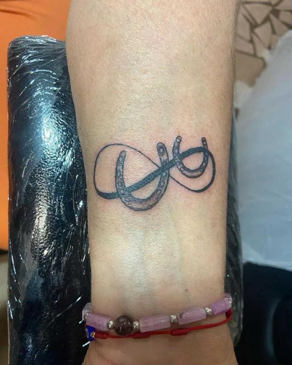 Infinity and double horseshoe tattoo