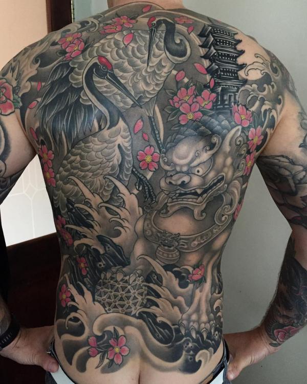 Japanese crane and foo dog with ball of flower of life full back tattoo