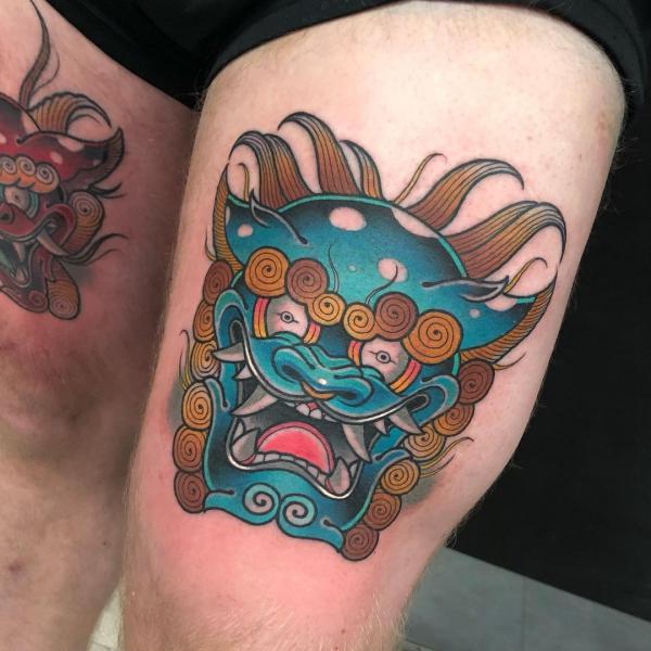 Japanese foo dog above knee tattoo