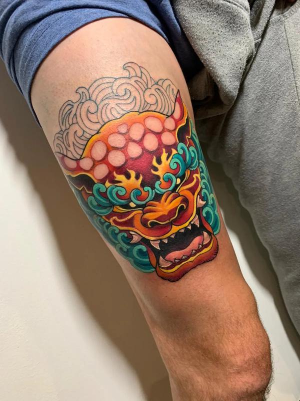 Japanese foo dog tattoo above knee