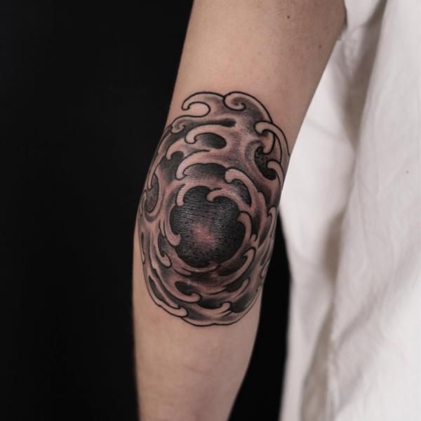 Japanese wave elbow tattoo