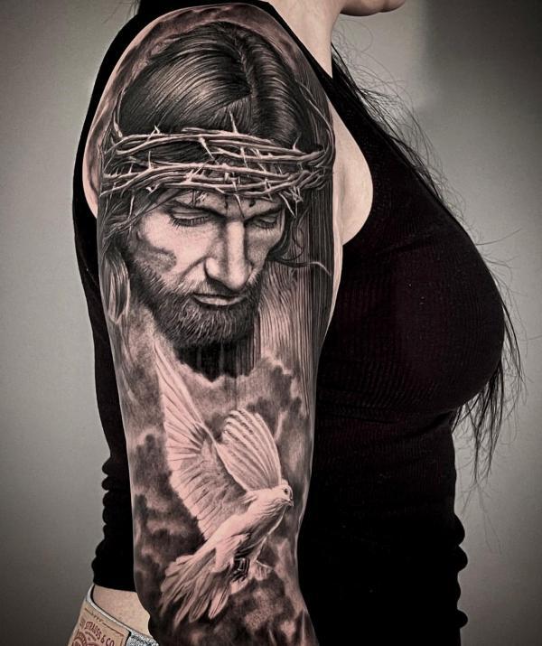 Jesus and dove sleeve tattoo