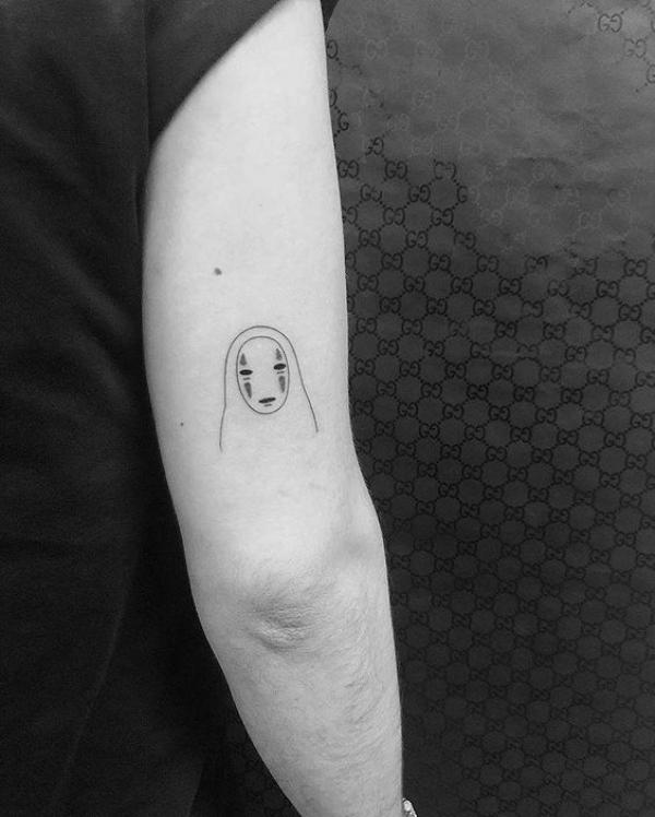 Kaonashi line work back of arm tattoo