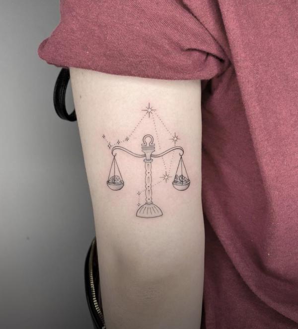 Libra and constellation back of arm tattoo