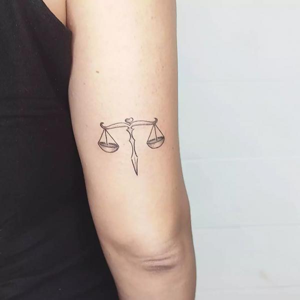 Libra back of arm tattoo