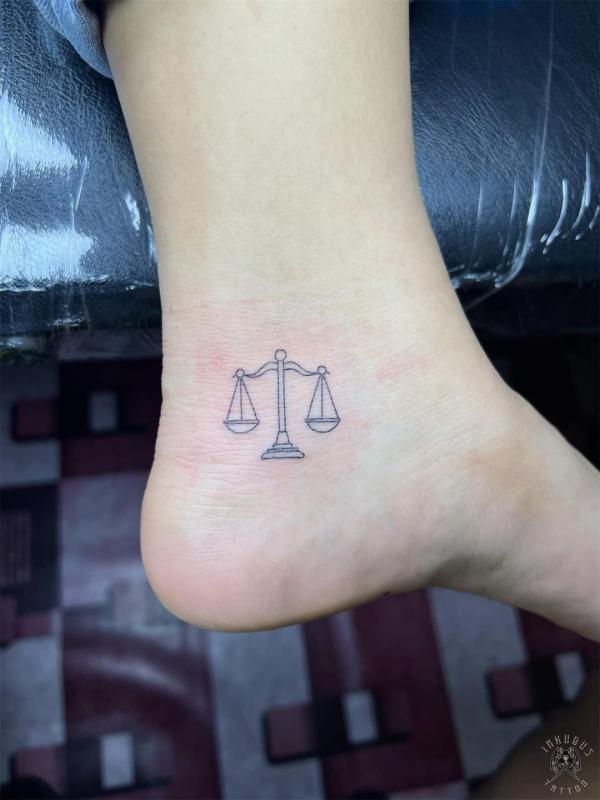 Libra outline foot tattoo